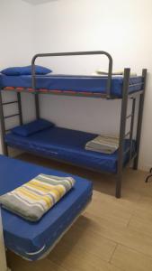 a blue bunk bed with a towel sitting on it at Albergue Santiago Apostol in Logroño