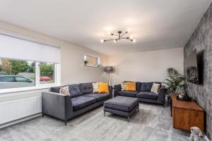 a living room with two couches and a window at 33 Lochgreen Avenue in Troon