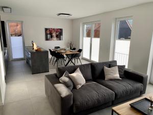 a living room with a couch and a table at APPARTEMENT3 in Dahn