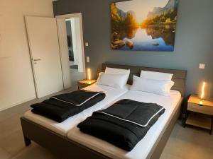 a bedroom with two beds with black pillows at APPARTEMENT3 in Dahn