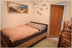 a bedroom with a bed and a wall with signatures at Appartement Franz in Bad Ischl