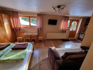 a living room with two beds and a couch at Wynajem u Andzi in Zakopane