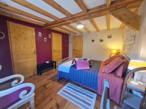 a bedroom with a bed in a room with wooden floors at Chambre Familiale 4 Pers, 2ème Étage, Repas Traditionnels, Terrasse, Parking Hiver - FR-1-589-565 in Rochesson