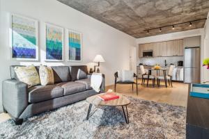 a living room with a couch and a table at Contemporary City Living Apartments in Nashville in Nashville