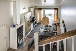 a kitchen with white appliances and a dining room at Skivillas 28 A 3 in Ukkohalla