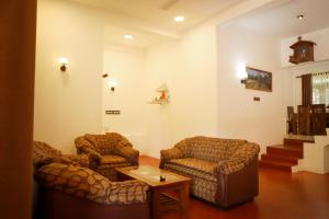 a living room with two couches and a table at Punida villa in Matara
