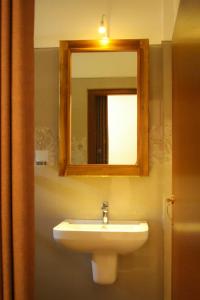 a bathroom with a sink and a mirror at Punida villa in Matara