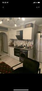 a kitchen with a stove and a refrigerator at Ardor’s apartment in Antalya