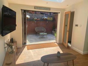 a living room with a door open to a patio at The Hideaway in Emsworth