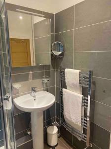 a bathroom with a sink and a mirror at The Hideaway in Emsworth