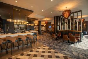 a lobby with a bar and some chairs and tables at Talbot Hotel Clonmel in Clonmel