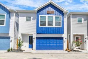 una casa con puertas azules de garaje en Prolific Chic Getaway Ft Style Comfort Location, en Houston
