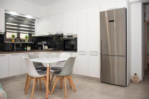 A kitchen or kitchenette at Christina Apartment