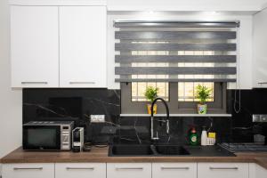 A kitchen or kitchenette at Christina Apartment