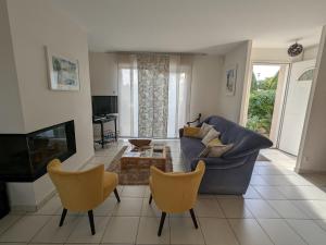 DounouxにあるMaison Plain-Pied à 10 min d'Epinal: Jardin Clos, BBQ, WIFI, Draps et Ménage Inclus - FR-1-589-606のリビングルーム(青いソファ、椅子2脚付)