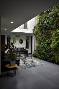 a living room with a large wall of plants at Hotel DC Feria in Bogotá