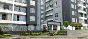 an apartment building with a staircase in front of it at Like a Home - 2Bedrooms - QueenBed - Balcony - Parking - 7Th FLOOR in Quito
