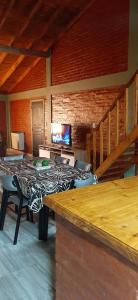 a room with a table with chairs and a television at ALQUILER TEMPORARIO EN TRELEW in Trelew