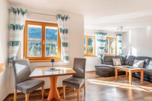 a living room with a couch and a table at Bergblick-Ferienwohnungen in Bad Hindelang