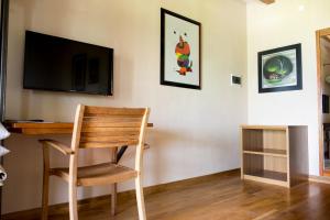 a room with a desk and a television and a chair at Private Room close to Beautiful Parma in Montechiarugolo
