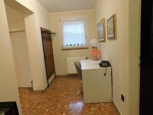 a room with a white refrigerator and a window at Casa dolce casa in Aviano +11 photos