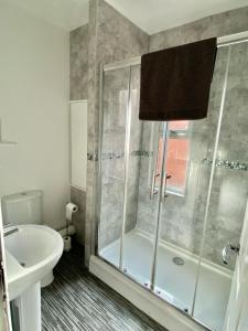 a bathroom with a shower and a sink at Brooklyn Place by SG Property Group in Crewe