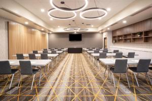 a conference room with tables and chairs and a podium at Holiday Inn Glendale - Stadium & Ent Dist by IHG in Glendale +15 photos