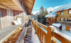 a balcony of a ski lodge with snow on it at Chalet La Grande Ourse Meribel - superior apartment in Les Allues