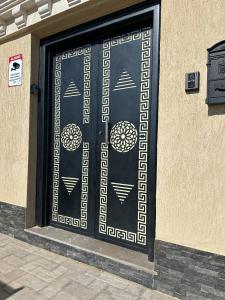 a black door with white designs on a building at Luxury Villa, Central Ac, Bbq, Ideal For Events in Rejiche