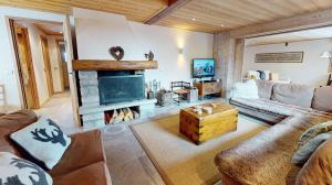 a living room with a couch and a fireplace at Chalet La Grande Ourse Meribel - superior apartment in Les Allues