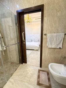 a bathroom with a shower and a toilet and a sink at Luxury Villa, Central Ac, Bbq, Ideal For Events in Rejiche