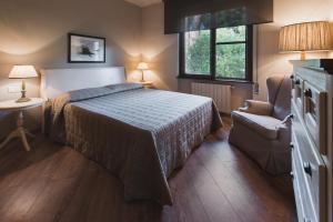 Postel nebo postele na pokoji v ubytování Roccamare Resort - Ville e Appartamenti