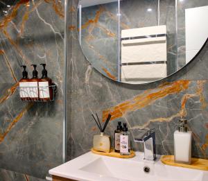 a bathroom with a sink and a mirror at Playa de San Lorenzo in Gijón