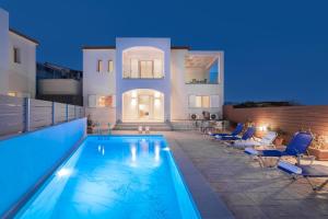 a villa with a swimming pool at night at Splendid Zakynthos Villa - 2 Bedrooms - Ocean Pool Villa - Close to Amenities - Walking Distance to Beach in Tsilivi