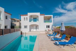 a villa with a swimming pool and blue chairs at Splendid Zakynthos Villa - 2 Bedrooms - Ocean Pool Villa - Close to Amenities - Walking Distance to Beach in Tsilivi