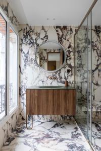 a bathroom with a sink and a mirror at HIGHSTAY - Luxury Serviced Apartments - Centre Pompidou in Paris