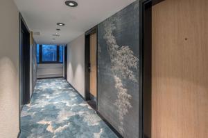a hallway with a large painting on the wall at DoubleTree by Hilton Paris Bougival in Bougival