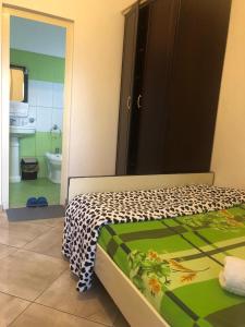a bedroom with a bed with a checkered blanket at Tafilaj Apartments in Durrës