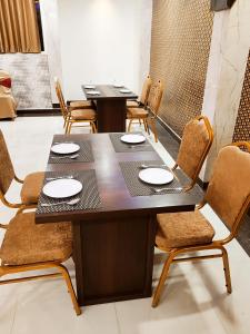a dining room with two tables and chairs at HOTEL JVS PALACE in Gorakhpur