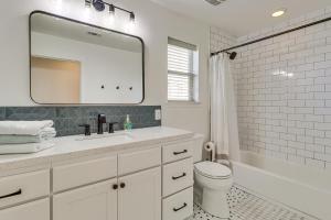 a bathroom with a sink and a toilet and a mirror at Centrally Located Austin Home with Private Patio! in Austin +19 photos