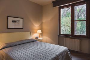 Postel nebo postele na pokoji v ubytování Roccamare Resort - Ville e Appartamenti