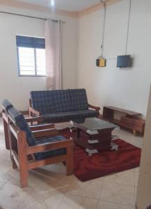 a living room with a couch and a coffee table at Bugara Homestay in Kisoro