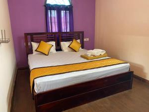 a bedroom with a bed with two towels on it at MR Resort Room type in Ooty