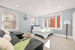 a living room with a couch and a bed at New! Cozy Apt in Center City! in Philadelphia