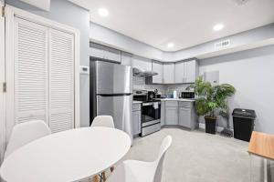 a kitchen with a table and chairs and a refrigerator at New! Cozy Apt in Center City! in Philadelphia