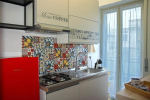 a kitchen with a sink and a red refrigerator at Casa Graziosa in Ercolano