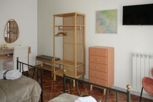a living room with a book shelf and a dresser at Casa Graziosa in Ercolano