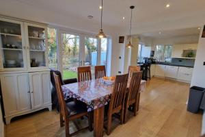 a dining room and kitchen with a table and chairs at Forest view cottage in Nottingham