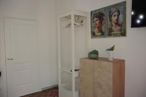 a room with a white closet and a wooden cabinet at Casa Graziosa in Ercolano +47 photos