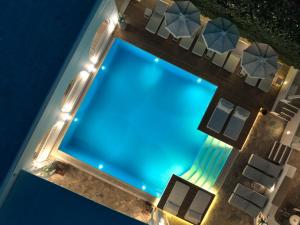 an overhead view of a swimming pool at night at Stelia Mare Boutique Hotel in Naousa